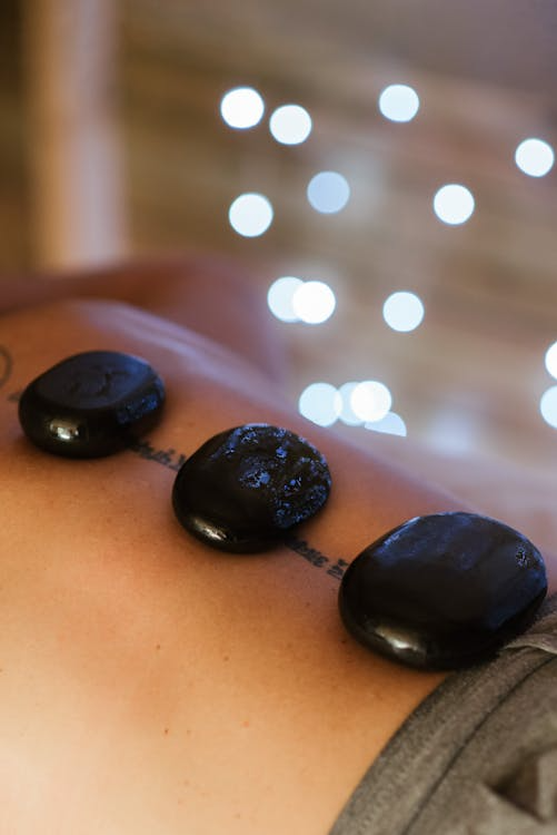 close-up of hot stones on a person's back