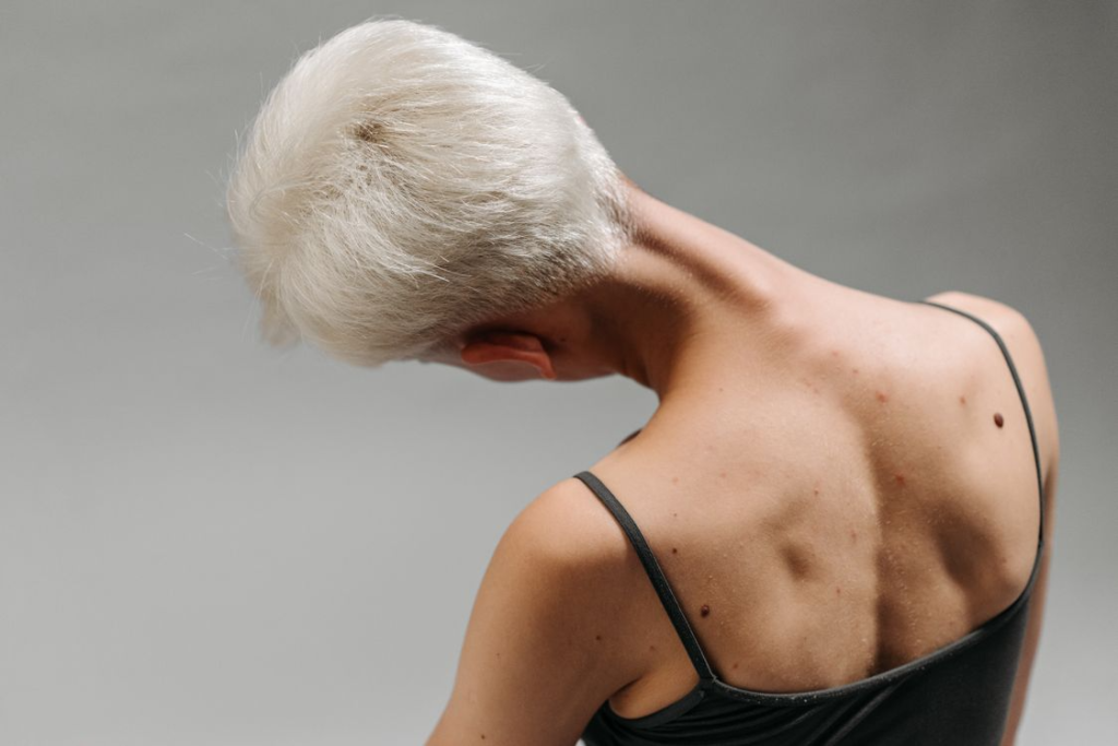 person stretching neck and shoulders