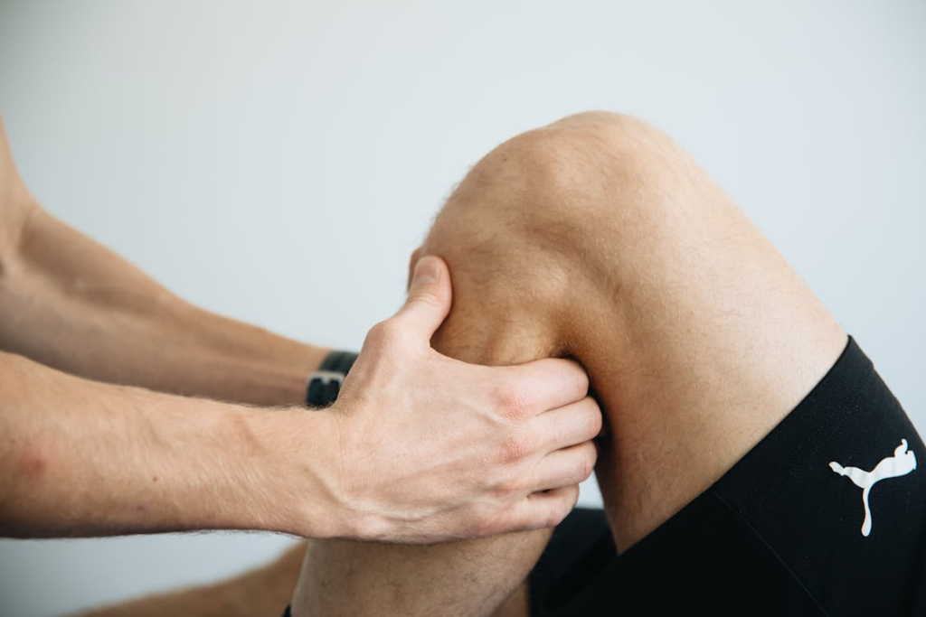 a massage therapist massaging a client's knee