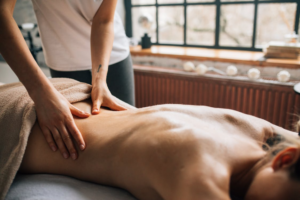 a woman lying down on a massage chair getting a massage