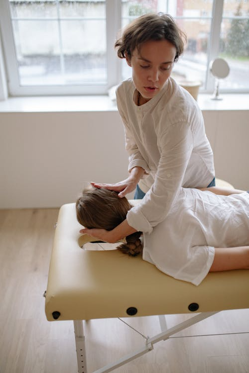 a woman getting a neck massage to reduce stiffness