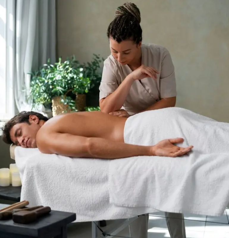 A professional providing a back massage to the person. 