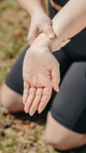 a person holding their wrist after strain or discomfort