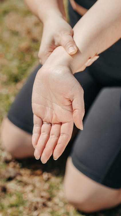 a person holding their wrist after strain or discomfort