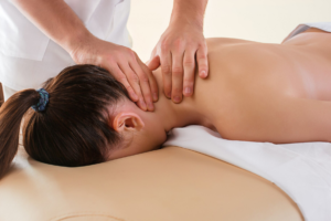 A person getting their neck tissues massaged for relaxation.
