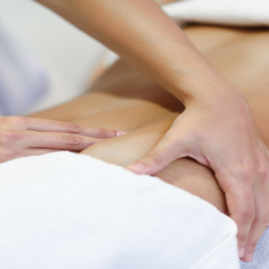 A person massaging somebody’s back tissues.