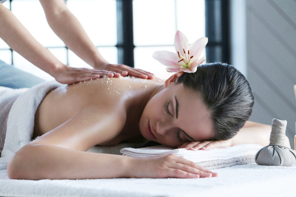a person receiving a soothing back massage in a peaceful spa room