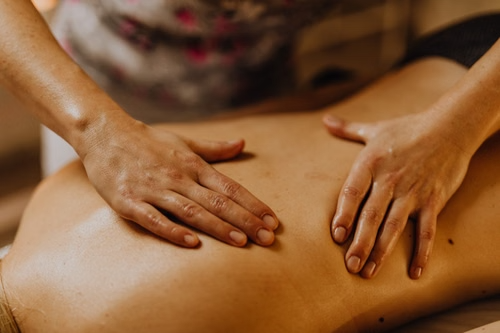 A massage therapist massaging a client’s back