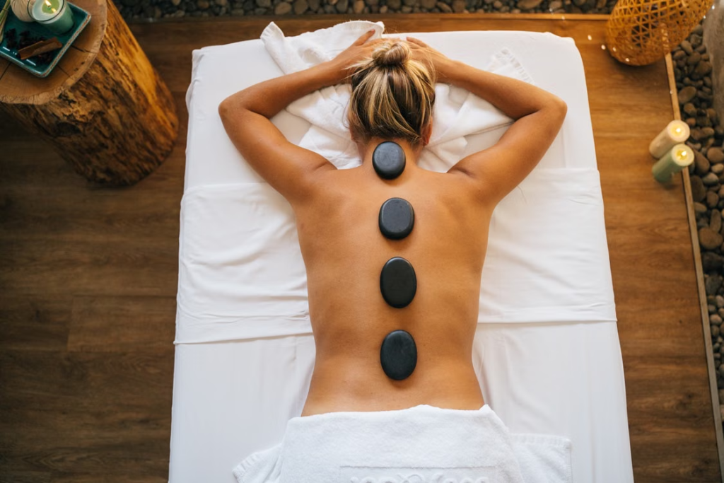 This photo shows a woman with hot stones on her back.