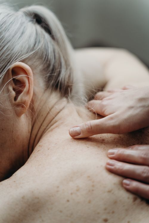 An image of a woman getting a neck and shoulder massage