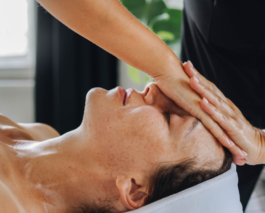 This image shows a therapist applying calming head massage.