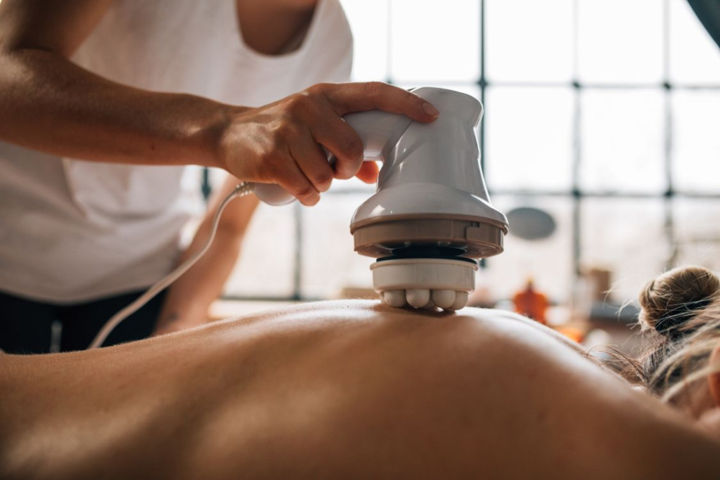An image of a woman getting a massage with an electronic massager