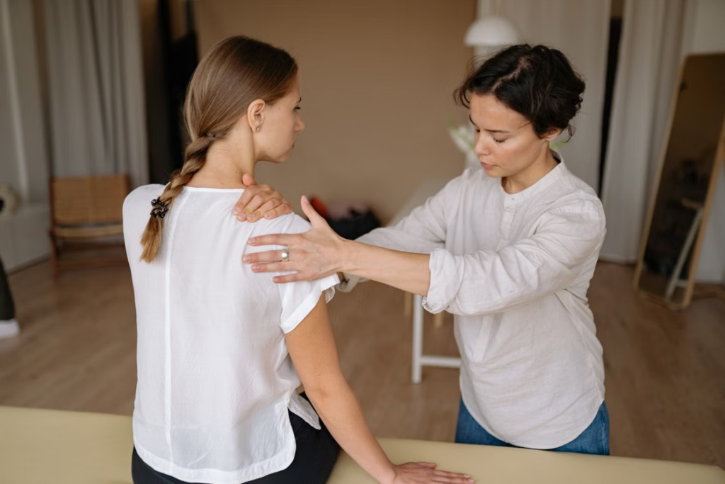 An image of a young woman getting a massage for neck pain