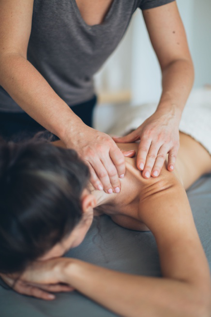Massage therapist providing a calming wellness treatment for stress relief and muscle tension 