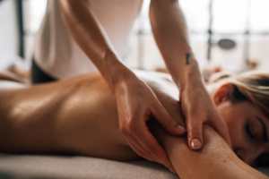 Therapist providing deep tissue massage treatment to help relieve muscle tension and support recovery